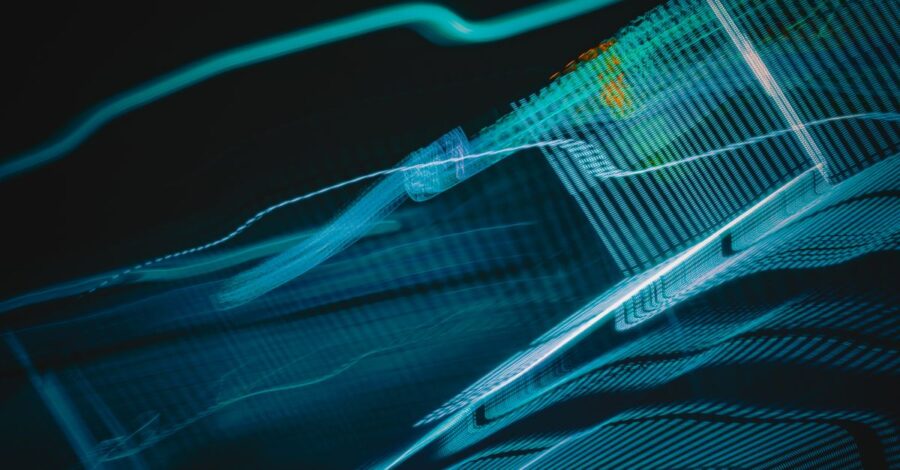 Abstract digital artwork with blue light streaks on a dark background, creating a futuristic feel.